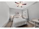 Cozy bedroom featuring a queen bed with a padded headboard and a ceiling fan at 1324 Sandybrook Ln, Wake Forest, NC 27587