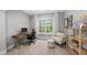 This bedroom has a computer desk with a black chair and a shelf with decorations at 1324 Sandybrook Ln, Wake Forest, NC 27587