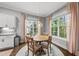 Bright dining area with hardwood floors, natural light, and a modern chandelier at 1324 Sandybrook Ln, Wake Forest, NC 27587