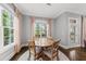 Charming dining nook featuring a wood table, stylish rug, and large windows for natural light at 1324 Sandybrook Ln, Wake Forest, NC 27587