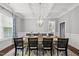 Elegant dining room with coffered ceiling, wainscoting, and modern chandelier at 1324 Sandybrook Ln, Wake Forest, NC 27587