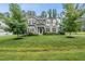 Charming two-story home with a well-manicured lawn and mature trees in a desirable neighborhood at 1324 Sandybrook Ln, Wake Forest, NC 27587