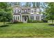 Beautiful two-story gray home with lush green lawn and manicured landscaping at 1324 Sandybrook Ln, Wake Forest, NC 27587