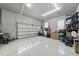 Spacious garage with a light-colored epoxy floor and ample storage space for vehicles and other items at 1324 Sandybrook Ln, Wake Forest, NC 27587
