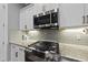 Up close shot of the kitchen featuring granite counters, a gas range, and tiled backsplash at 1324 Sandybrook Ln, Wake Forest, NC 27587