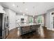 Open kitchen with a large island, stainless steel appliances, and pendant lighting at 1324 Sandybrook Ln, Wake Forest, NC 27587