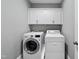Well-organized laundry room featuring a front-load washer, dryer, and plenty of cabinet space at 1324 Sandybrook Ln, Wake Forest, NC 27587