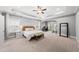 Spacious main bedroom featuring a tray ceiling, ample natural light, and a sitting area at 1324 Sandybrook Ln, Wake Forest, NC 27587