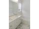 Bathroom with double sink vanity, soaking tub, and window at 137 Wintermist Dr, Cary, NC 27513