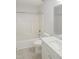 A clean, bright bathroom featuring a shower-tub combo, white fixtures, and tile floors at 137 Wintermist Dr, Cary, NC 27513