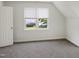 Bright bedroom featuring neutral gray carpet, white trim, and plenty of natural light at 137 Wintermist Dr, Cary, NC 27513