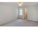 Spacious bedroom with neutral carpeting, natural light, and an open closet at 137 Wintermist Dr, Cary, NC 27513