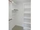 Walk-in closet features built in white shelving and hanging rods at 137 Wintermist Dr, Cary, NC 27513
