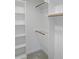 Walk-in closet features built-in white shelving and hanging rods at 137 Wintermist Dr, Cary, NC 27513