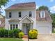Charming two-story home with shake siding, a front porch, and mature landscaping under a blue sky at 137 Wintermist Dr, Cary, NC 27513