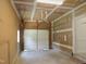 An unfinished garage featuring a roll up garage door and concrete floors at 137 Wintermist Dr, Cary, NC 27513