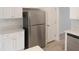 Close-up of stainless steel refrigerator with white cabinetry at 137 Wintermist Dr, Cary, NC 27513