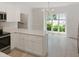 Open concept kitchen with stainless steel appliances and eat-in bar overlooking an airy dining room at 137 Wintermist Dr, Cary, NC 27513