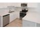 Close-up of a modern kitchen with stainless steel appliances and white cabinets at 137 Wintermist Dr, Cary, NC 27513