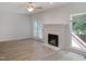 Bright living room featuring a fireplace, wood-look floors, and glass doors leading to the backyard at 137 Wintermist Dr, Cary, NC 27513