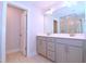 Modern bathroom featuring a double sink vanity with neutral cabinets, large mirror, and a glass-enclosed shower at 1441 Rosepine Dr Dr, Cary, NC 27519