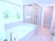 Elegant bathroom featuring a soaking tub and a glass-enclosed shower, creating a luxurious spa experience at 1441 Rosepine Dr Dr, Cary, NC 27519
