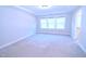 Spacious carpeted bedroom with tray ceilings and large windows, offering natural light and comfort at 1441 Rosepine Dr Dr, Cary, NC 27519