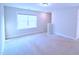 Bright bedroom with a large window and neutral carpeting at 1441 Rosepine Dr Dr, Cary, NC 27519