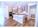 Bright kitchen with stainless steel appliances, white countertops, subway tile backsplash, and modern pendant lighting at 1441 Rosepine Dr Dr, Cary, NC 27519