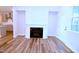 Bright living room features a fireplace, hardwood floors, and access to the outdoors at 1441 Rosepine Dr Dr, Cary, NC 27519