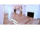 Open concept living room with bright kitchen, fireplace, and hardwood floors at 1441 Rosepine Dr Dr, Cary, NC 27519