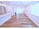 Open concept living room features hardwood flooring, modern lighting, a fireplace, and an open concept to the kitchen at 1441 Rosepine Dr Dr, Cary, NC 27519