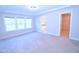 A carpeted main bedroom with ample natural light and an ensuite bathroom with lots of space at 1441 Rosepine Dr Dr, Cary, NC 27519