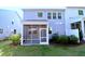 Rear exterior view showcasing the home's screened-in porch and landscaped backyard at 1441 Rosepine Dr Dr, Cary, NC 27519