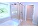 Modern glass shower with tiled walls and a rain shower head, paired with a luxurious bathtub at 1441 Rosepine Dr Dr, Cary, NC 27519