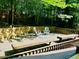 Wooden deck with chairs and shade trees in backyard at 1512 Cumberland Rd, Chapel Hill, NC 27514