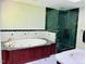 Luxurious bathroom featuring a soaking tub with marble surround and separate glass-enclosed shower at 1512 Cumberland Rd, Chapel Hill, NC 27514
