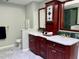 Primary bathroom features dual sinks with marble countertops and cherry cabinets at 1512 Cumberland Rd, Chapel Hill, NC 27514