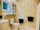 Cozy bathroom featuring a pedestal sink, tile flooring, and a decorative wallpaper at 1512 Cumberland Rd, Chapel Hill, NC 27514