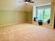 Spacious bedroom with a window nook, ceiling fan, and neutral carpet at 1512 Cumberland Rd, Chapel Hill, NC 27514