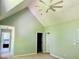 Open bedroom with ceiling fan, vaulted ceilings, and access to attached bathroom at 1512 Cumberland Rd, Chapel Hill, NC 27514