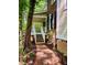 Inviting entrance with a brick walkway leading to a charming covered porch, complemented by lush greenery and classic home design at 1512 Cumberland Rd, Chapel Hill, NC 27514
