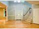 Spacious foyer boasts natural light, hardwood floors, an elegant staircase, and a beautifully designed front door at 1512 Cumberland Rd, Chapel Hill, NC 27514