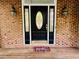 Elegant front door with decorative glass, flanked by sconces, offering a warm welcome on a classic brick facade at 1512 Cumberland Rd, Chapel Hill, NC 27514