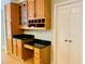 Kitchen area with beautiful wood cabinets, black granite countertops, and a spacious built-in desk at 1512 Cumberland Rd, Chapel Hill, NC 27514