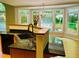 Kitchen island with granite counters and sink with large bay windows in the background at 1512 Cumberland Rd, Chapel Hill, NC 27514