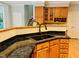 Kitchen island with granite counters and sink with the staircase in the background at 1512 Cumberland Rd, Chapel Hill, NC 27514