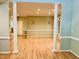 Open living room with hardwood floors, decorative columns, and ample natural light, creating an inviting and spacious atmosphere at 1512 Cumberland Rd, Chapel Hill, NC 27514
