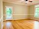 Living room offering hardwood floors, a ceiling fan, and a view of the outdoor deck at 1512 Cumberland Rd, Chapel Hill, NC 27514