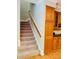 Carpeted staircase with wooden handrail leads to the upper level at 1512 Cumberland Rd, Chapel Hill, NC 27514